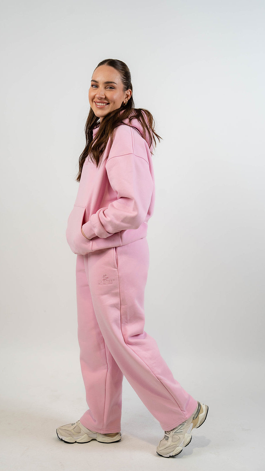 Person wearing a pink outfit on a white background